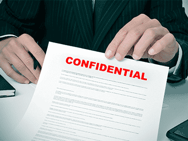 man holding up confidential bad credit loan agreement