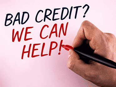 hand with pen and writing bad credit we can help